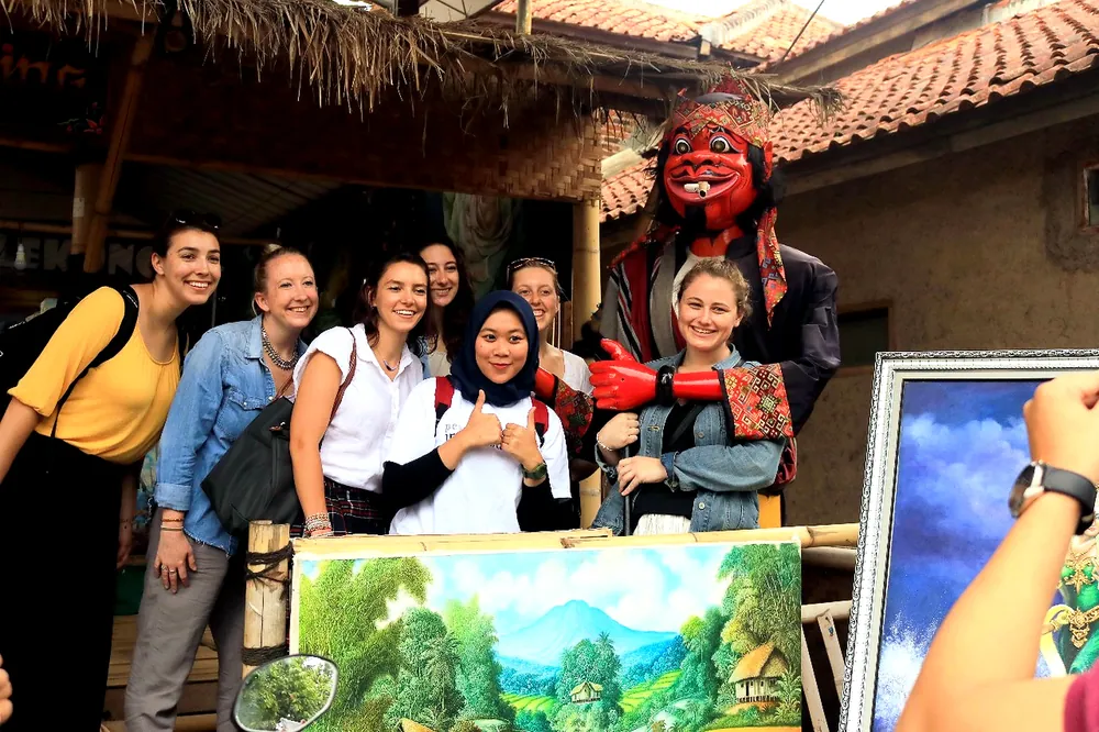 Students engaging with local artisans and a community in Indonesia through community-based tourism