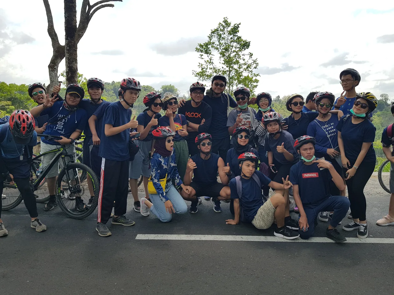 Student group on a guided educational cycling tour in Bali, helmets on and ready to ride through the countryside