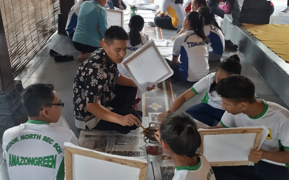 Students learning traditional Balinese papermaking in a hands-on community workshop, reflecting and growing through real experience