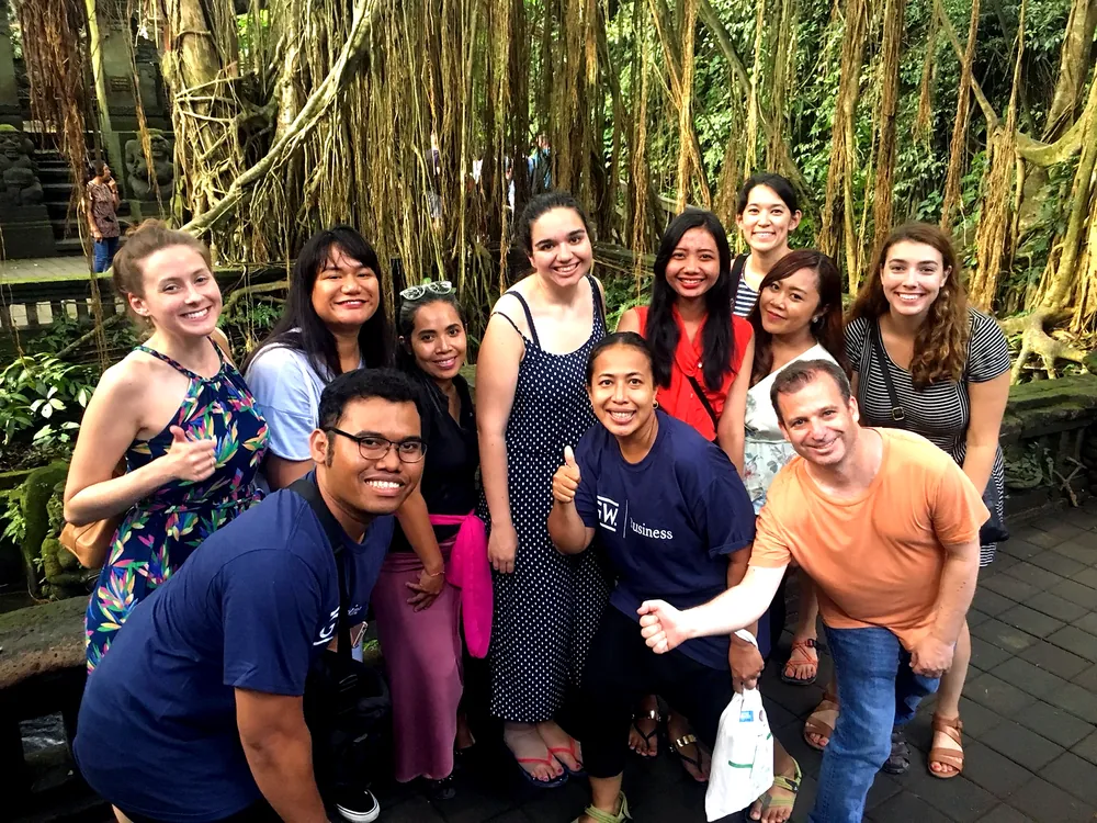 A student group exploring lush nature together, building teamwork and leadership in Indonesia