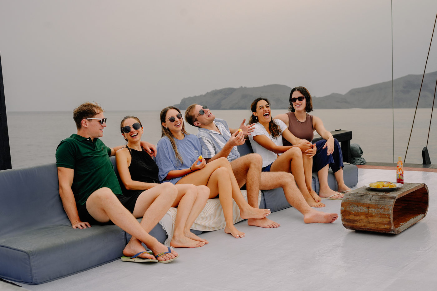 EastXperience guests and crew together on the deck of a liveaboard in Komodo
